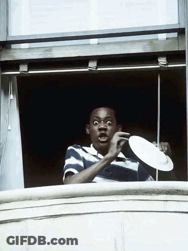 Man In Blue And White Striped Shirt Holding Plate GIF