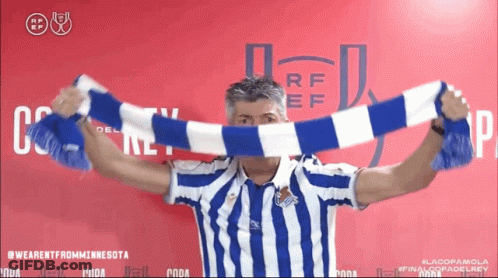 Man In Blue And White Striped Shirt Holding Scarf GIF