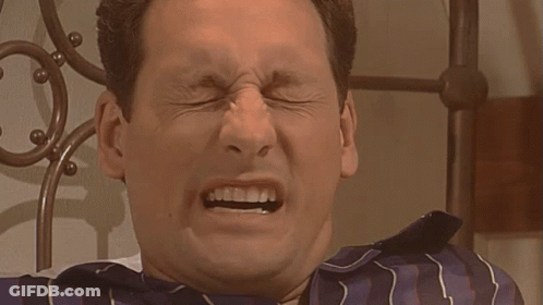 Man In Blue And White Striped Shirt Making Funny Face GIF