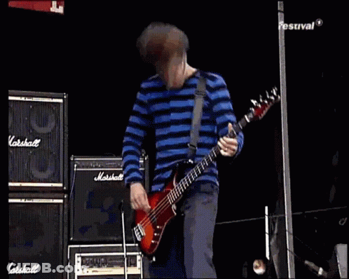 Man In Blue And White Striped Shirt Playing Bass Guitar GIF