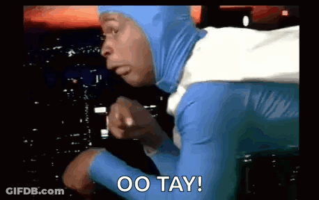 Man In Blue And White Superhero Costume Pointing Saying Oo Tay GIF
