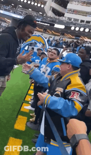 Man In Blue And Yellow Jacket With Letter R GIF