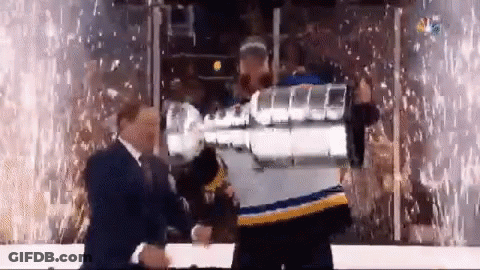 Man In Blue And Yellow Jersey Holding Hockey Trophy GIF