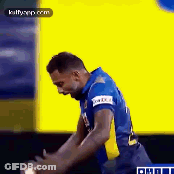 Man In Blue And Yellow Jersey Standing On Field GIF