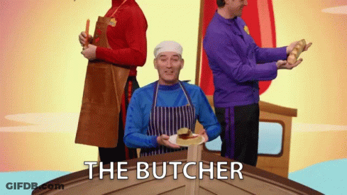 Man In Blue Apron Holding Plate With Butcher Text GIF
