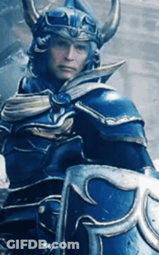 Man In Blue Armor And Helmet Holding Shield GIF