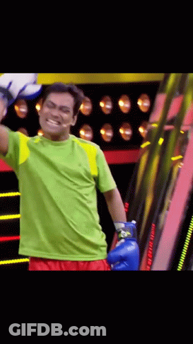 Man In Blue Boxing Gloves And Green Shirt GIF