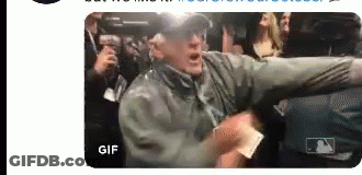 Man In Blue Brew Crew Sweatshirt In Front Of Scoreboard GIF