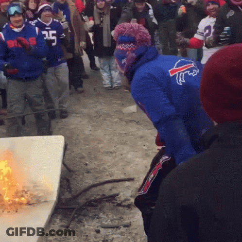 Man In Blue Buffalo Bills Jersey Standing In Front Of Fire GIF