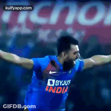 Man In Blue Byju's India Jersey Arms Outstretched GIF