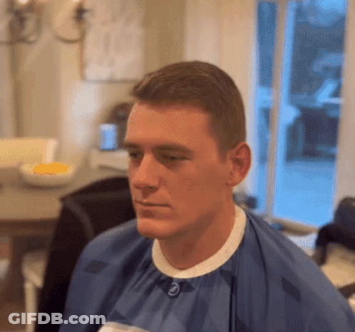 Man In Blue Cape With Letter E On Collar GIF