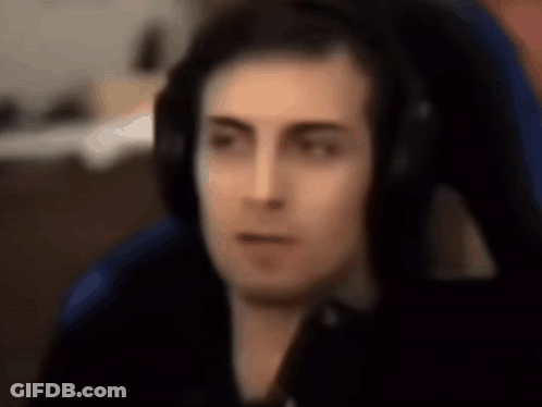 Man In Blue Chair Wearing Headphones Facing Camera GIF