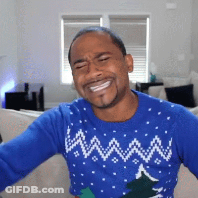 Man In Blue Christmas Sweater On Couch GIF