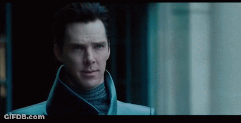 Man In Blue Coat And Turtleneck In Dark Room GIF