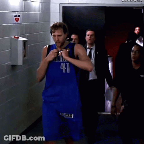 Man In Blue Dallas Jersey Walking Through Hallway GIF