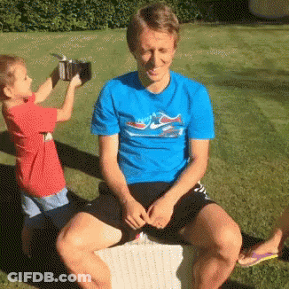 Man In Blue Dolphin Shirt Next To Boy GIF