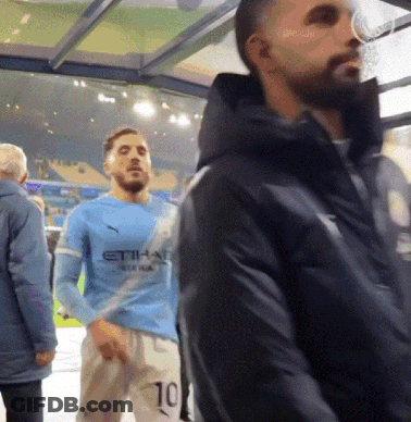 Man In Blue Etihad Jersey Beside Man In Black Jacket GIF
