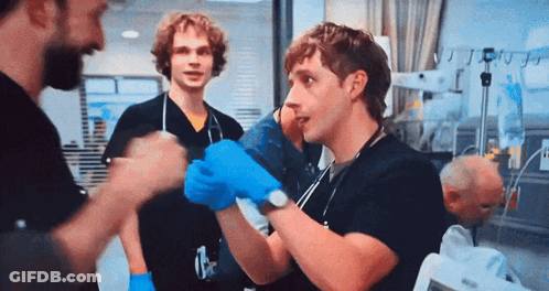 Man In Blue Gloves Talking In Hospital GIF