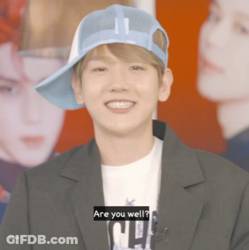 Man In Blue Hat And Black Jacket Says Are You Well GIF