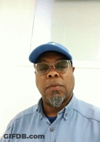Man In Blue Hat And Glasses Looking At Camera GIF