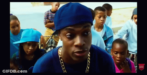 Man In Blue Hat And Gold Chain In Front Of Children GIF