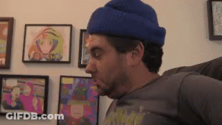 Man In Blue Hat And Gray Shirt Sitting On Couch GIF