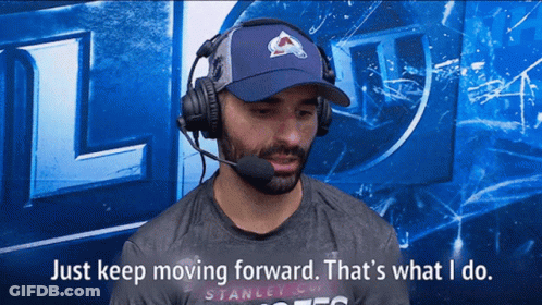 Man In Blue Hat And Headphones Says Keep Moving Forward GIF