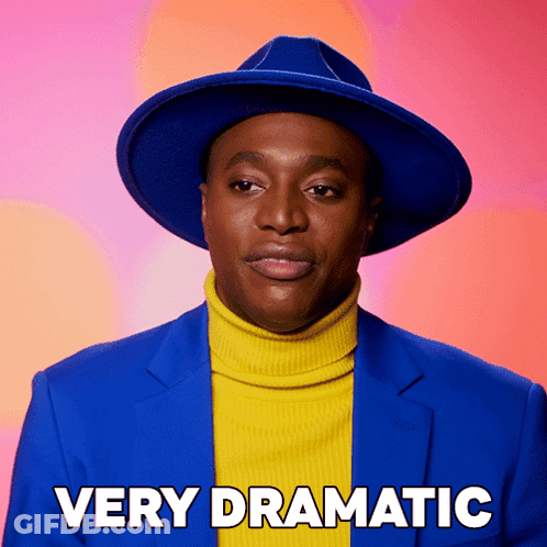 Man In Blue Hat And Yellow Turtleneck Very Dramatic GIF