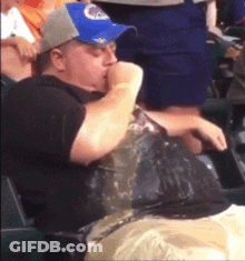 Man In Blue Hat Eating Chips In Stadium GIF