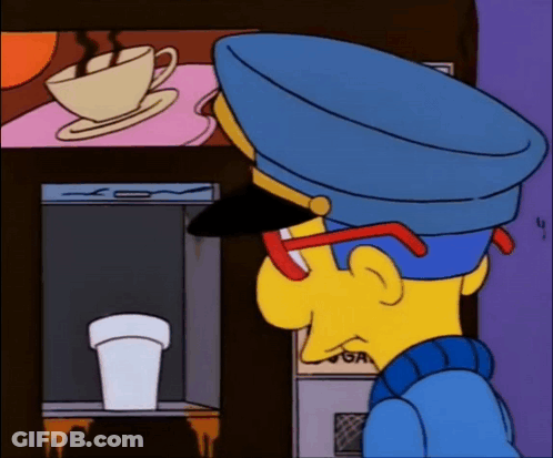 Man In Blue Hat Looking At Coffee Machine GIF