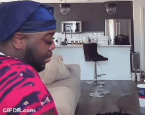 Man In Blue Hat Sitting GIF