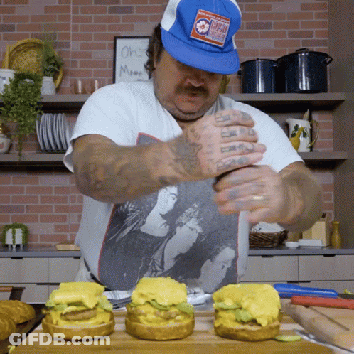 Man In Blue Hat With Chicago Prepares Hamburgers GIF