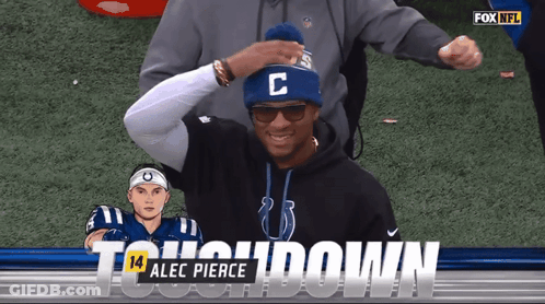 Man In Blue Hat With Letter C In Front Of Fox NFL Logo GIF