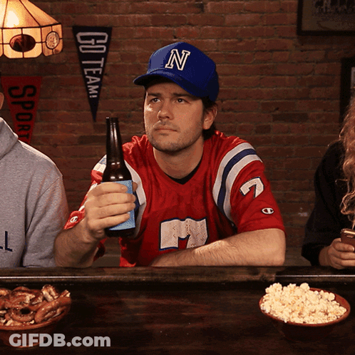 Man In Blue Hat With Letter N Holding Beer GIF