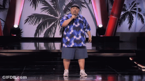 Man In Blue Hawaiian Shirt On Stage With Microphone GIF