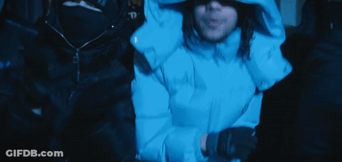 Man In Blue Hooded Jacket Sitting In Dark Room GIF