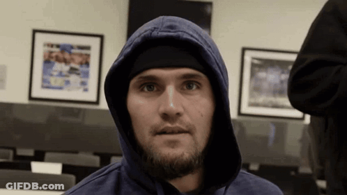 Man In Blue Hoodie And Black Headband Looking At Camera GIF