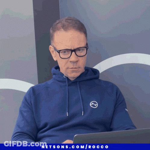 Man In Blue Hoodie And Glasses At Laptop GIF