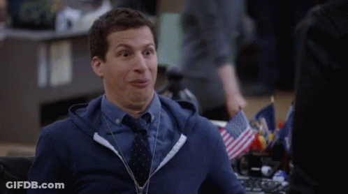 Man In Blue Hoodie And Tie Making Funny Face At Desk GIF