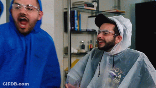 Man In Blue Hoodie And White Poncho With Moto GIF