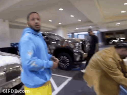 Man In Blue Hoodie And Yellow Shorts GIF