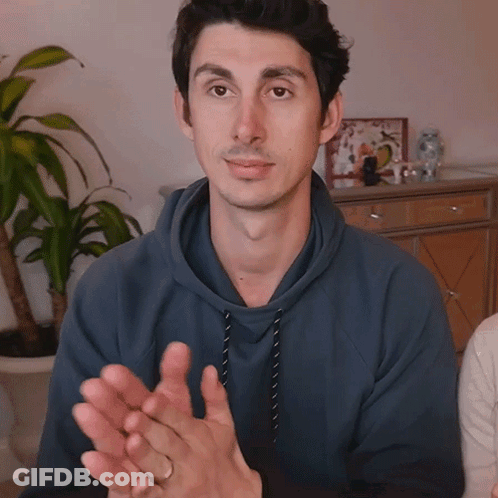 Man In Blue Hoodie Clapping With Plant GIF