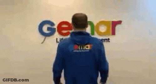 Man In Blue Hoodie In Front Of Gerar Sign GIF