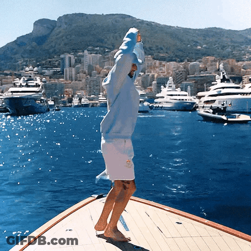 Man In Blue Hoodie On Boat In Ocean GIF