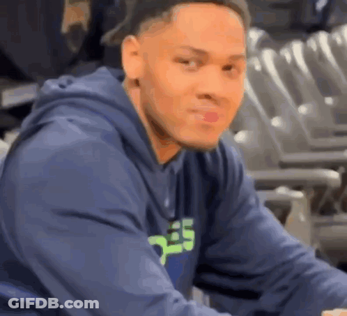 Man In Blue Hoodie Sitting In Stadium GIF
