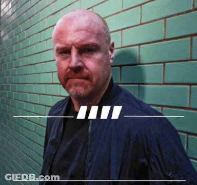 Man In Blue Jacket And Green Tiled Wall GIF