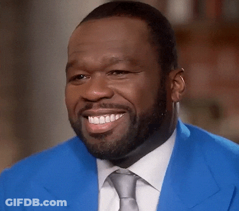 Man In Blue Jacket And Tie Smiles GIF