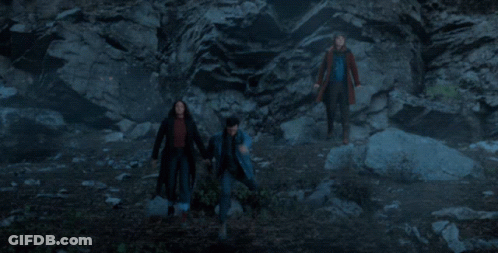 Man In Blue Jacket At Rock Wall GIF