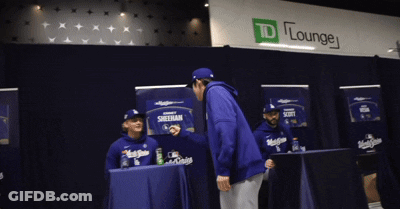 Man In Blue Jacket At TD Lounge Sign GIF