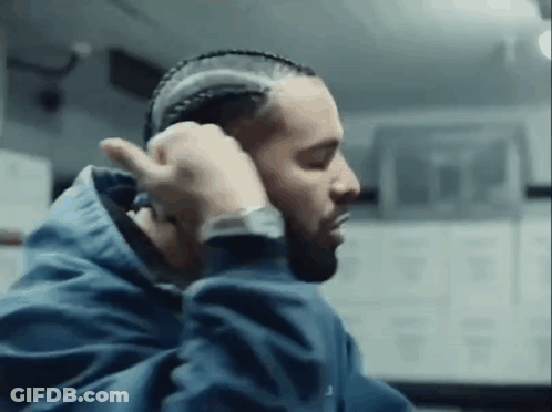 Man In Blue Jacket Braiding Hair GIF